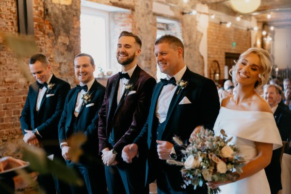 Groom and groomsmen bride holding flowers