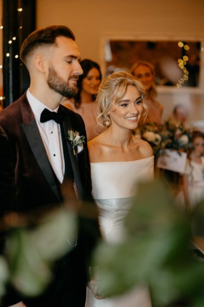 Bride and groom at alter smiling