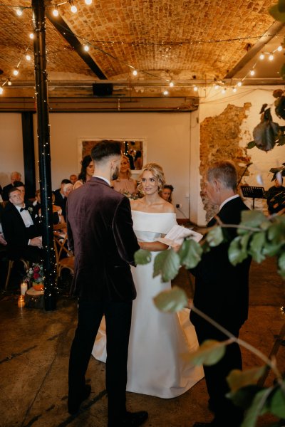 Bride and groom officiant at alter during ceremony