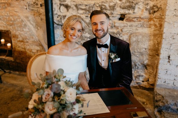 Bride and groom signing documents