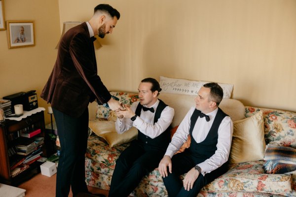 Groom and groomsmen sitting down