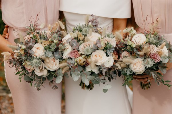 Bridesmaids bouquets up close and bride