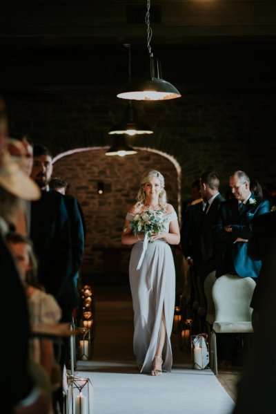 Bridesmaid walks down the aisle