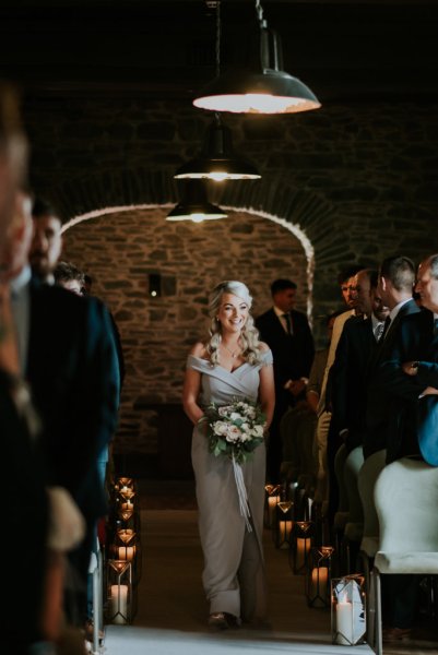 Bridesmaid walks down the aisle