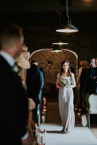 Bridesmaid walks down the aisle