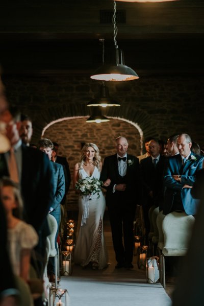 Father of the bride walks down the aisle guests