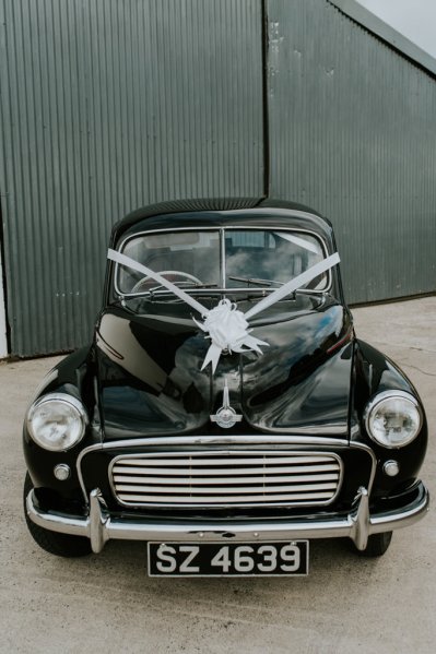 Black wedding car with ribbon/bow on it