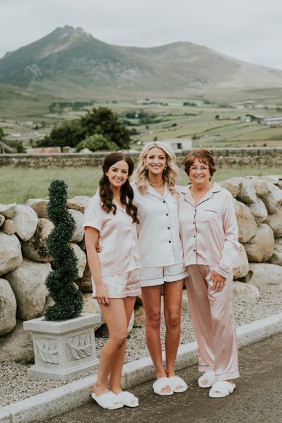 Bridesmaids and bride farm setting mountains landscape