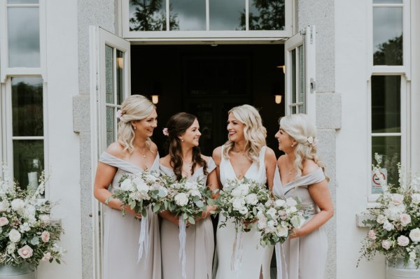 Bride and bridesmaids holding flowers