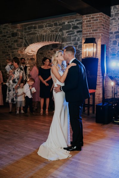 Bride and groom dance on dancefloor setting