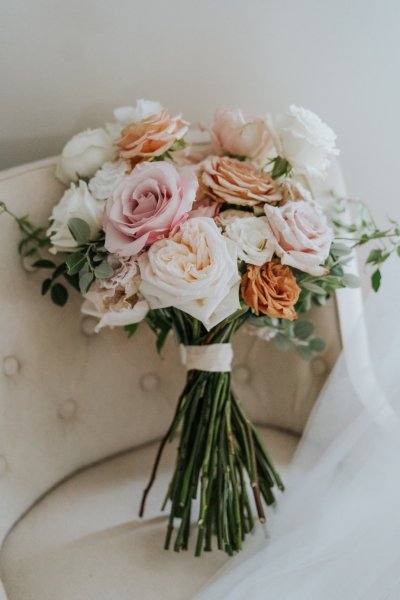 Close up of white and pink roses/flowers sitting on chair