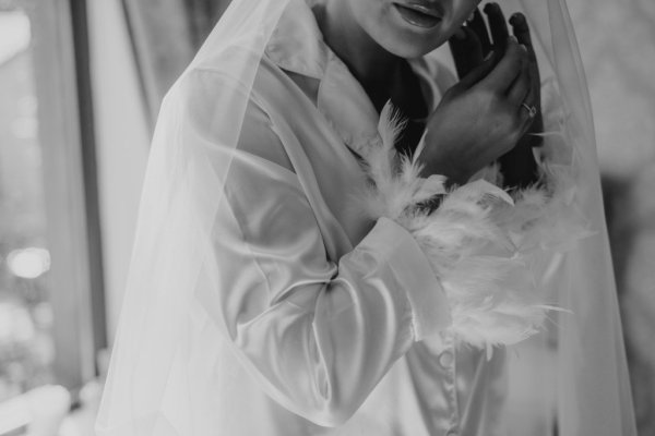 Black and white bride getting ready feather detail