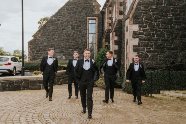 Groom and groomsmen outside of wedding venue exterior