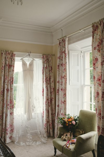 Bridal gown/dress hanging by window