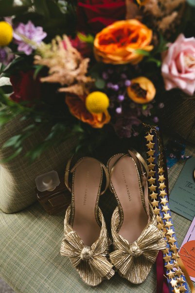 Flowers orange roses and gold bridal heels/shoes