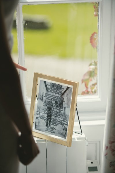 Wooden photo frame at window