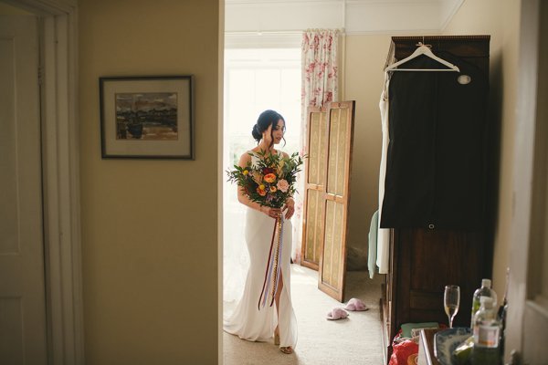 Bride holding bouquet in room