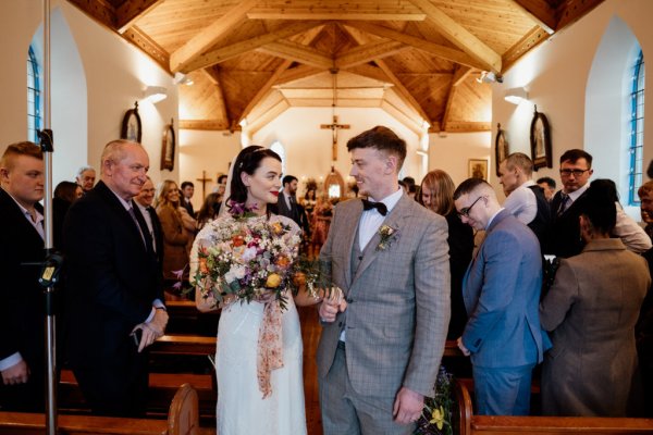 Bride and groom look at each other during wedding ceremony