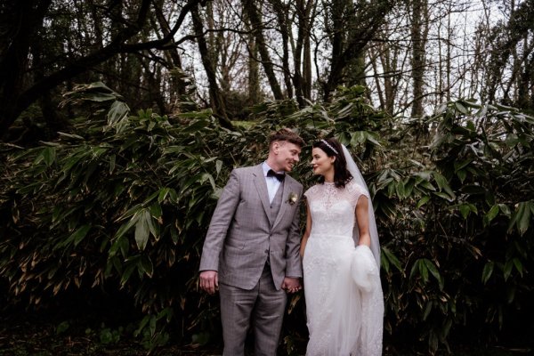 Bride and groom in front of tree detail forest park holding each other