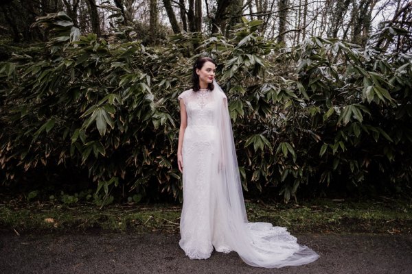 Bride in front of trees in forest park veil detail