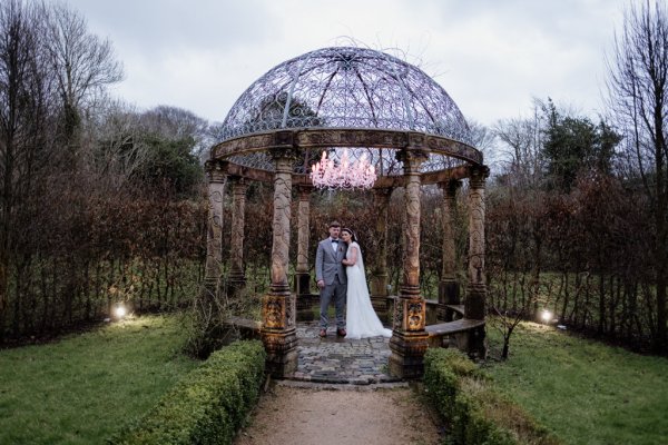 Bride and groom in park/garden walking