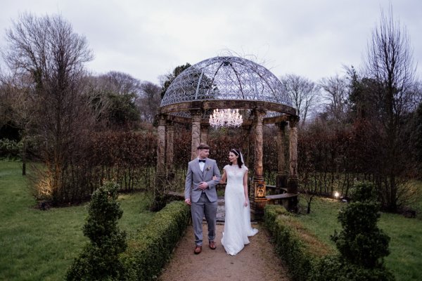 Bride and groom in park/garden walking