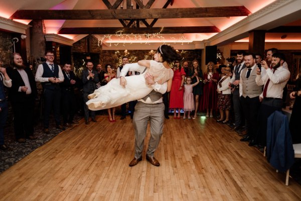 Bride and groom dance on the dancefloor in front of guests