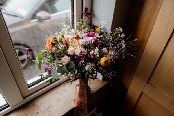 Flowers bouquet roses sitting at window