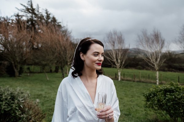 Bride holding glass of champagne prosecco