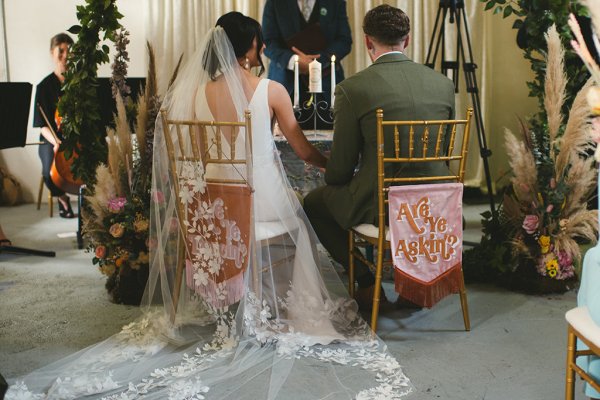 Bride and groom seated from behind