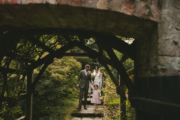 Little girl mother and father bride groom in garden