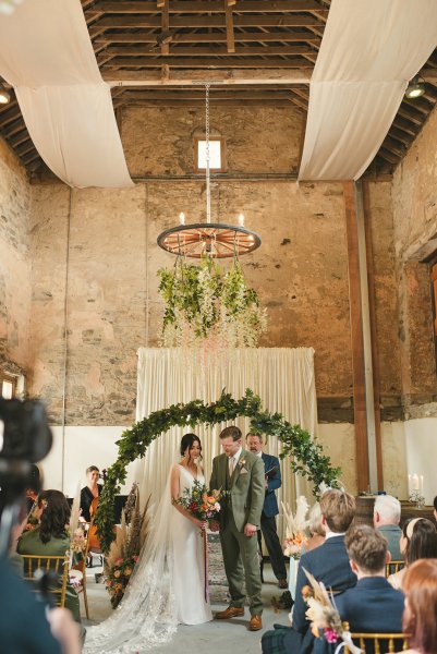 Bride and groom stand at alter in church