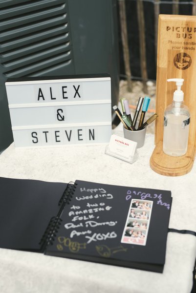 Alex & Steven sign on table