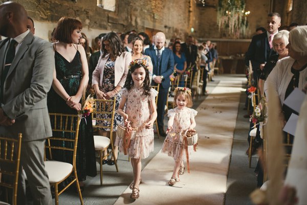 Flower girls walk down the aisle