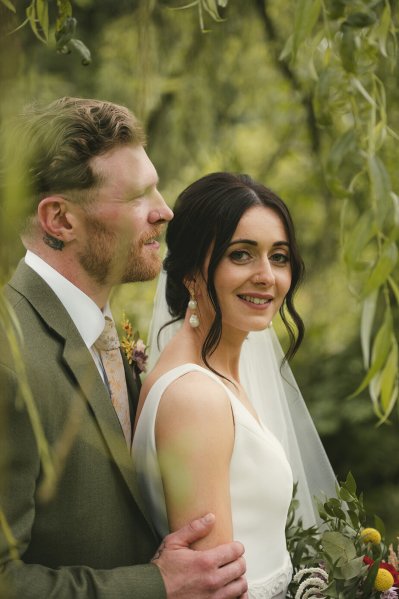 Bride and groom in garden tree