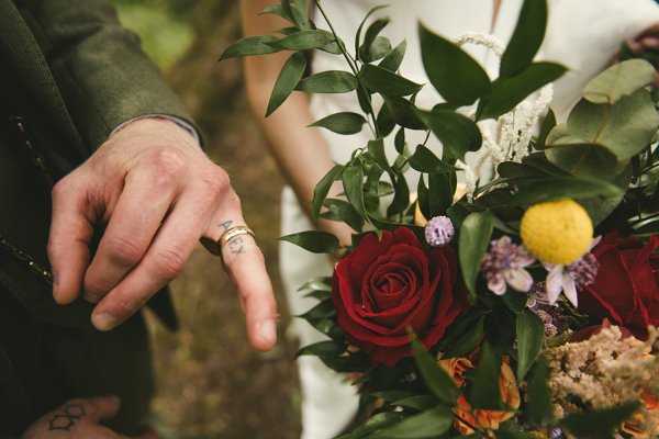 Bride and groom ring and red rose flower details