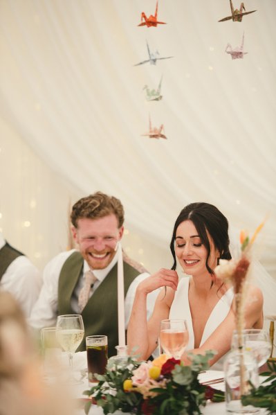 Bride and groom smiling laughing