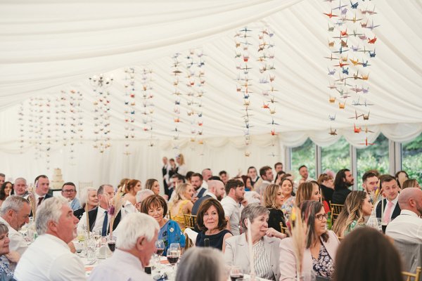 Atmosphere shot of guests clapping for couple