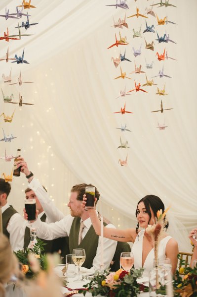 Bride and groom cheers with Guinness and bottle of Coke