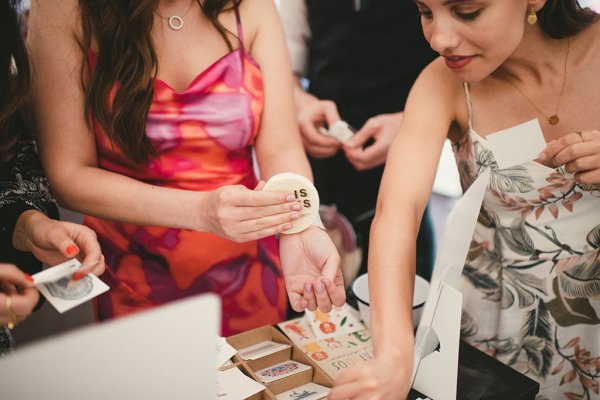 Guests pick up temporary tattoos picking from designs