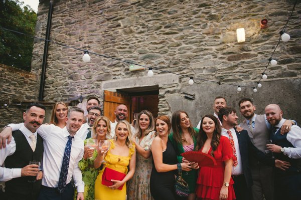 Group shot of guests with drinks in hand