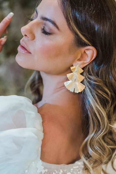 Bride close up gold earrings ring jewelry hand detail