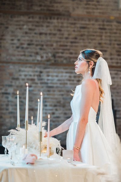 Veil bride bridal gown/dress standing at table flower candle detail