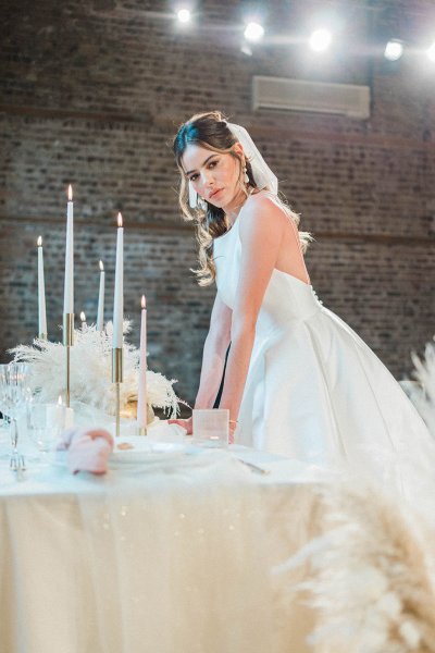 Veil bride bridal gown/dress standing at table flower candle detail