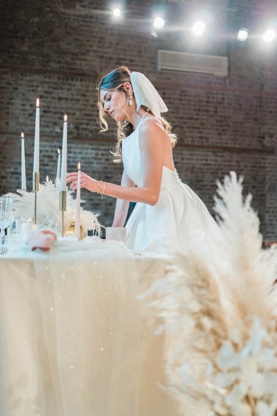 Veil bride bridal gown/dress standing at table flower candle detail