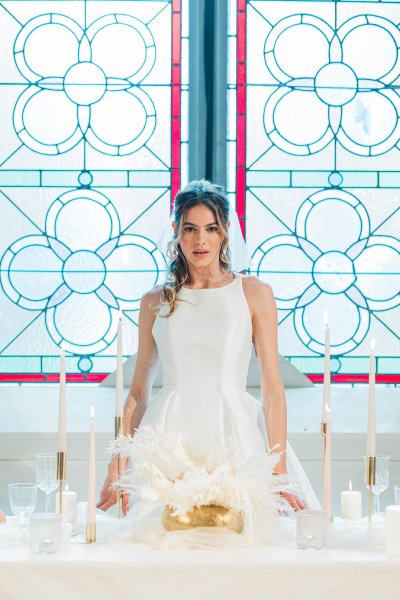 Bride standing in front of church window table interior