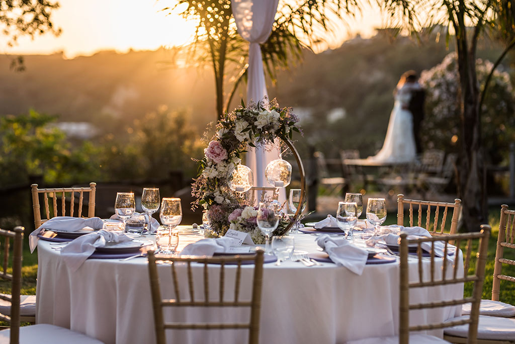 Wedding venue chairs dining table setting bride and groom in background