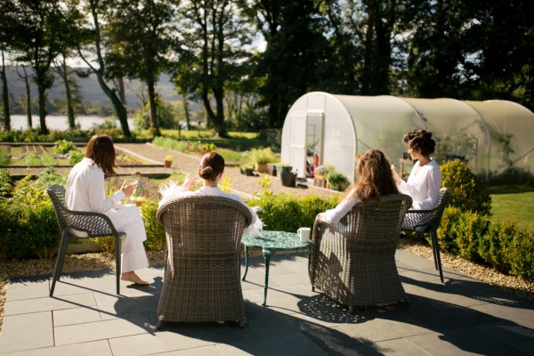 Bride and bridesmaids lounging in the sun before ceremony