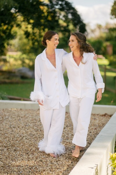 Bride and bridesmaid wearing bridalwear feather sleeves