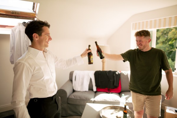 Groom and groomsmen share a beer together